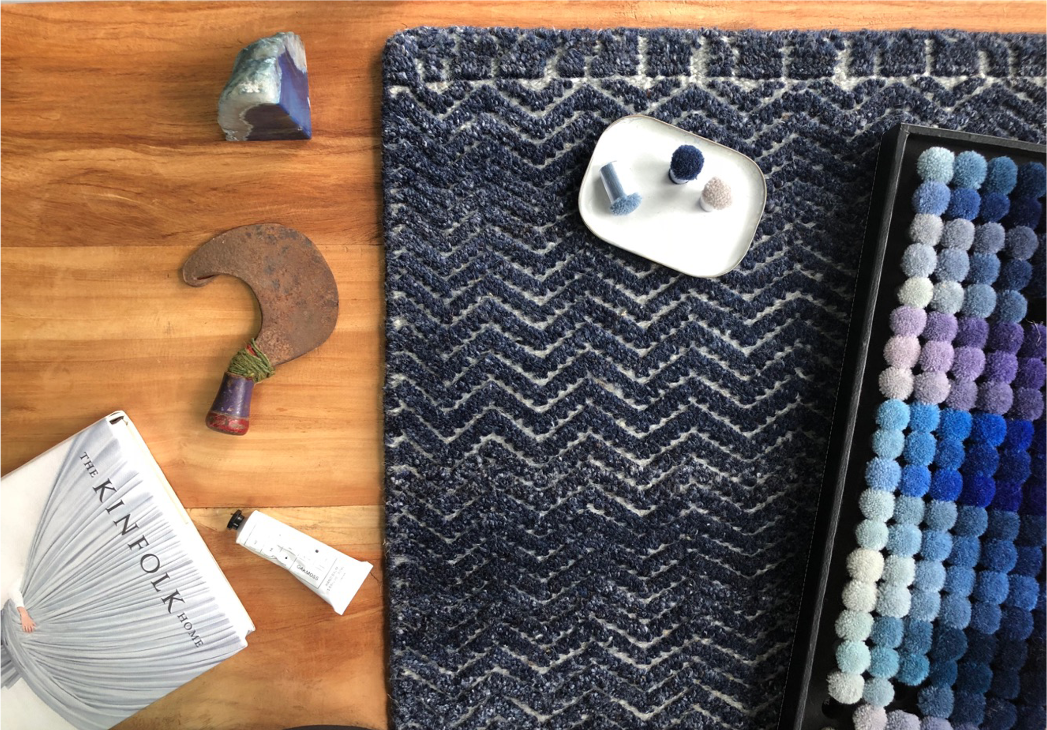 Eastern Mills design studio - color palette samples with chevron rug and design books